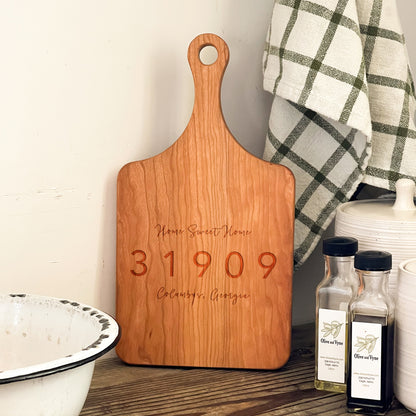 a wooden cutting board sitting on top of a table