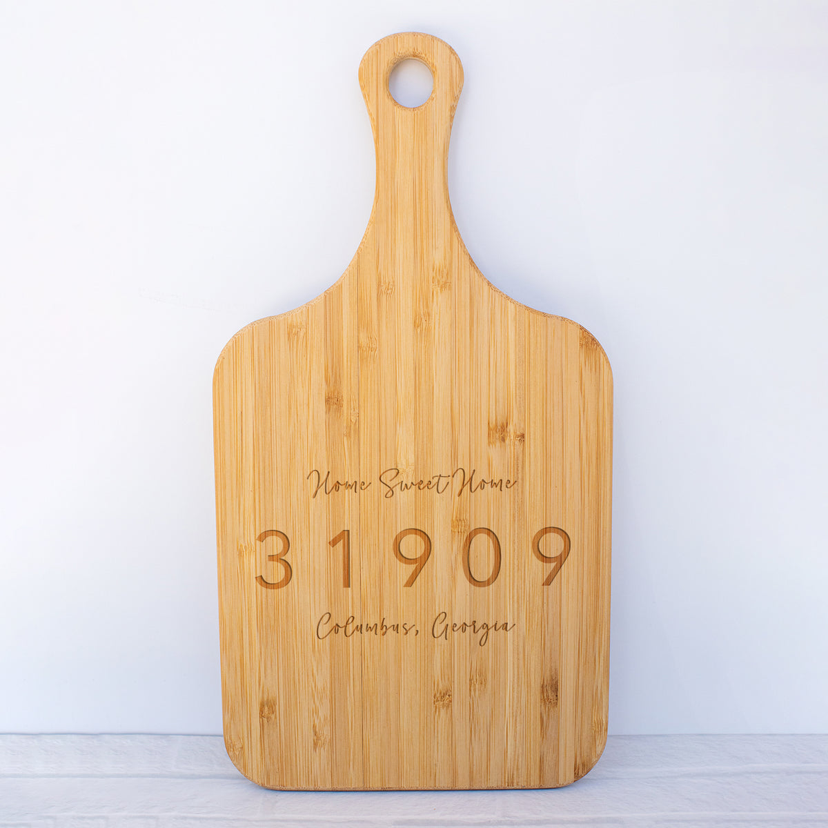 a cutting board with a name and date engraved on it