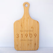 a cutting board with a name and date engraved on it