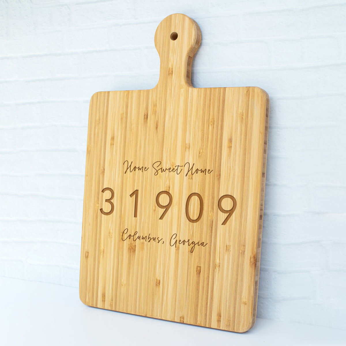 a cutting board with a name and date engraved on it