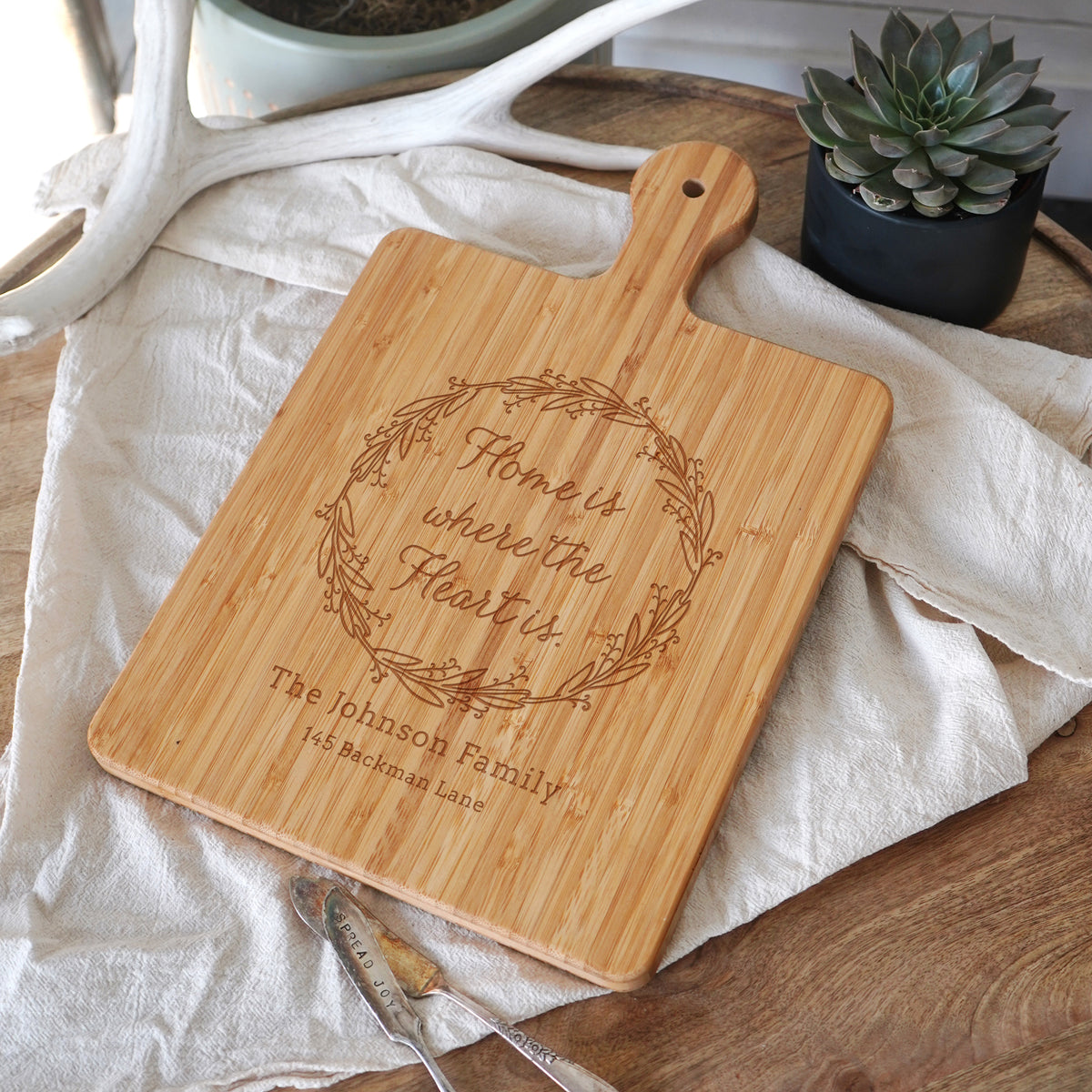 a wooden cutting board with a engraved message on it