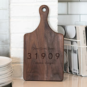a wooden cutting board sitting on top of a counter