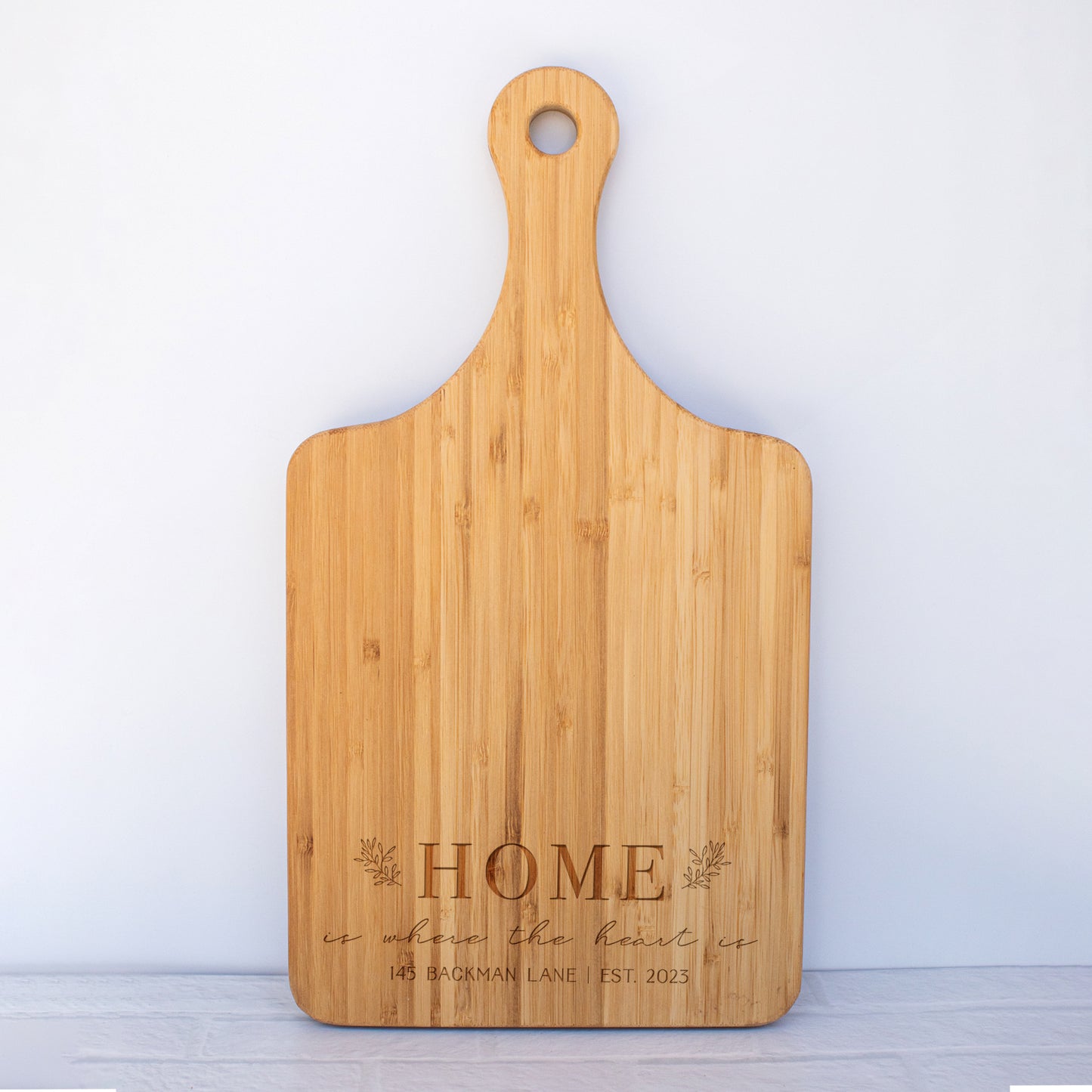 a cutting board with the words home on it