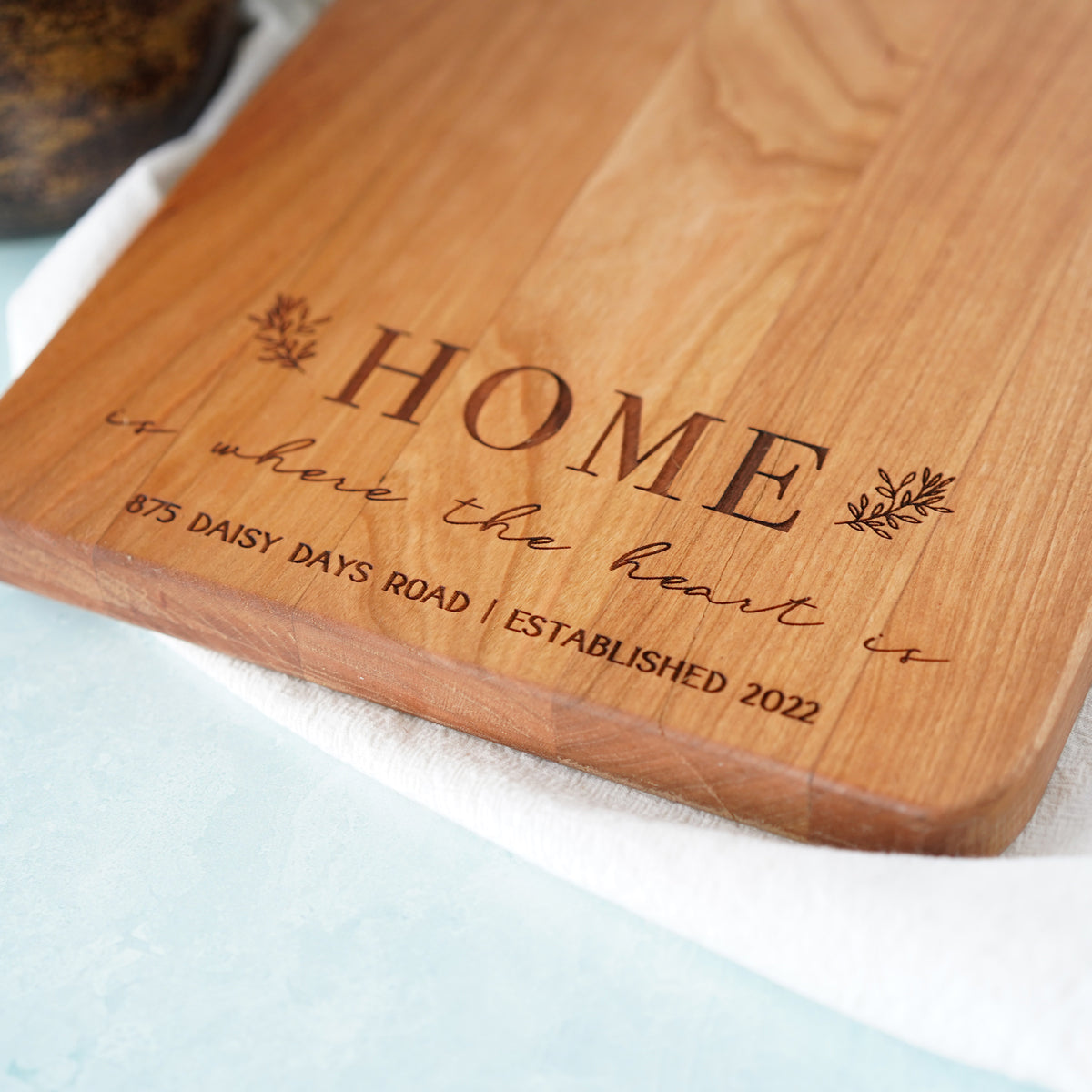 a wooden cutting board with a name on it