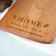 a wooden cutting board with a name on it