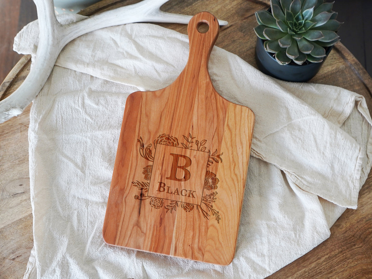 a wooden cutting board sitting on top of a table