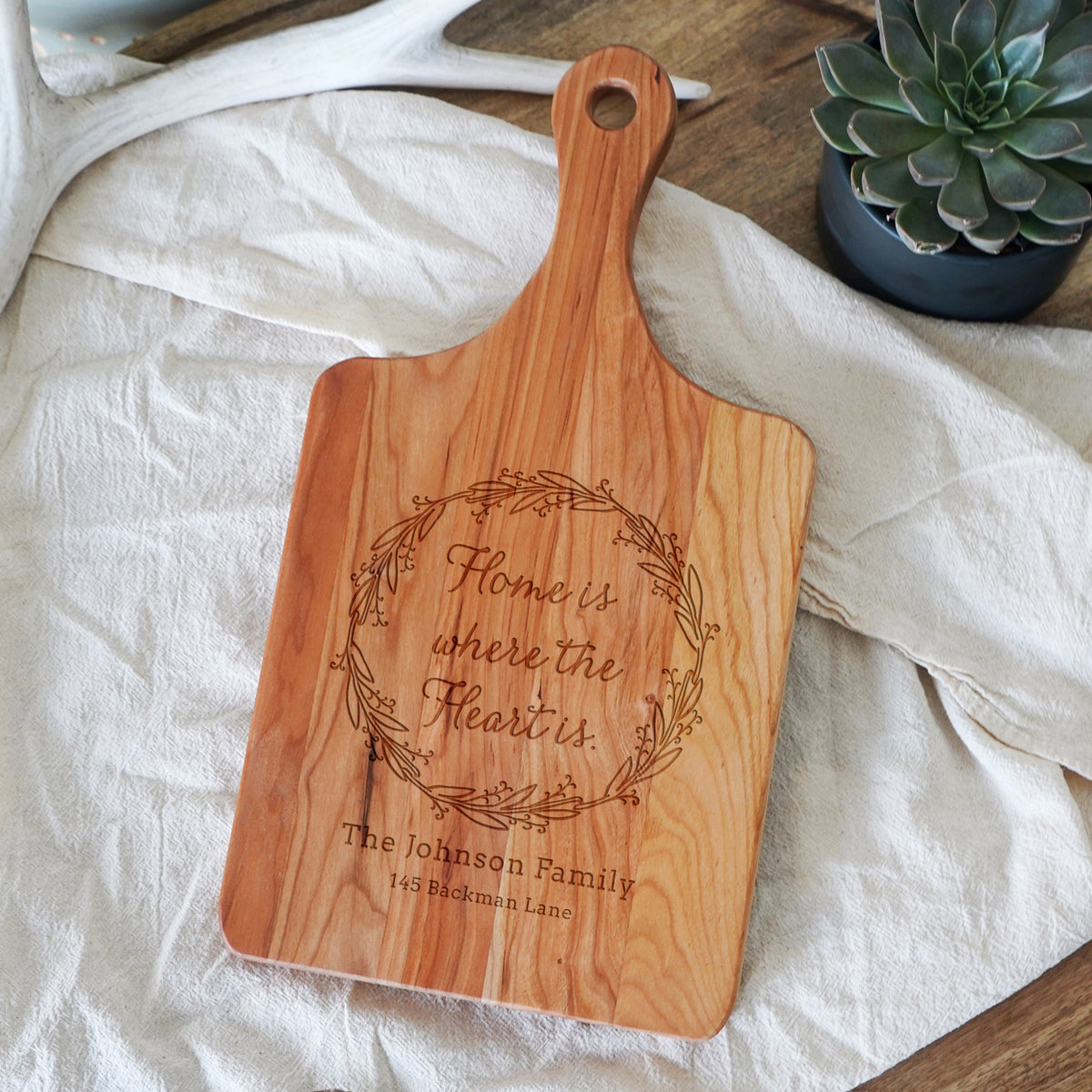 a wooden cutting board sitting on top of a table