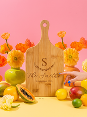 Large Initial Family Name Cutting Board in a colorful floral setting