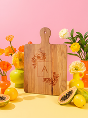 Floral Monogram Cutting Board in a colorful floral setting