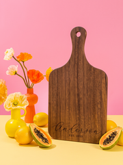 Custom Cursive Text Cutting Board in a colorful floral setting