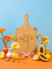 Couple Initials Wedding Cutting Board in a colorful floral setting