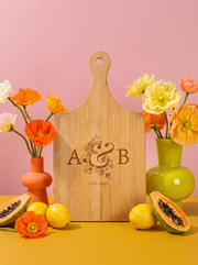 Couple Initials Wedding Cutting Board in a colorful floral setting