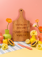 Everything Tastes Better at Grandma’s Cutting Board in a colorful floral setting