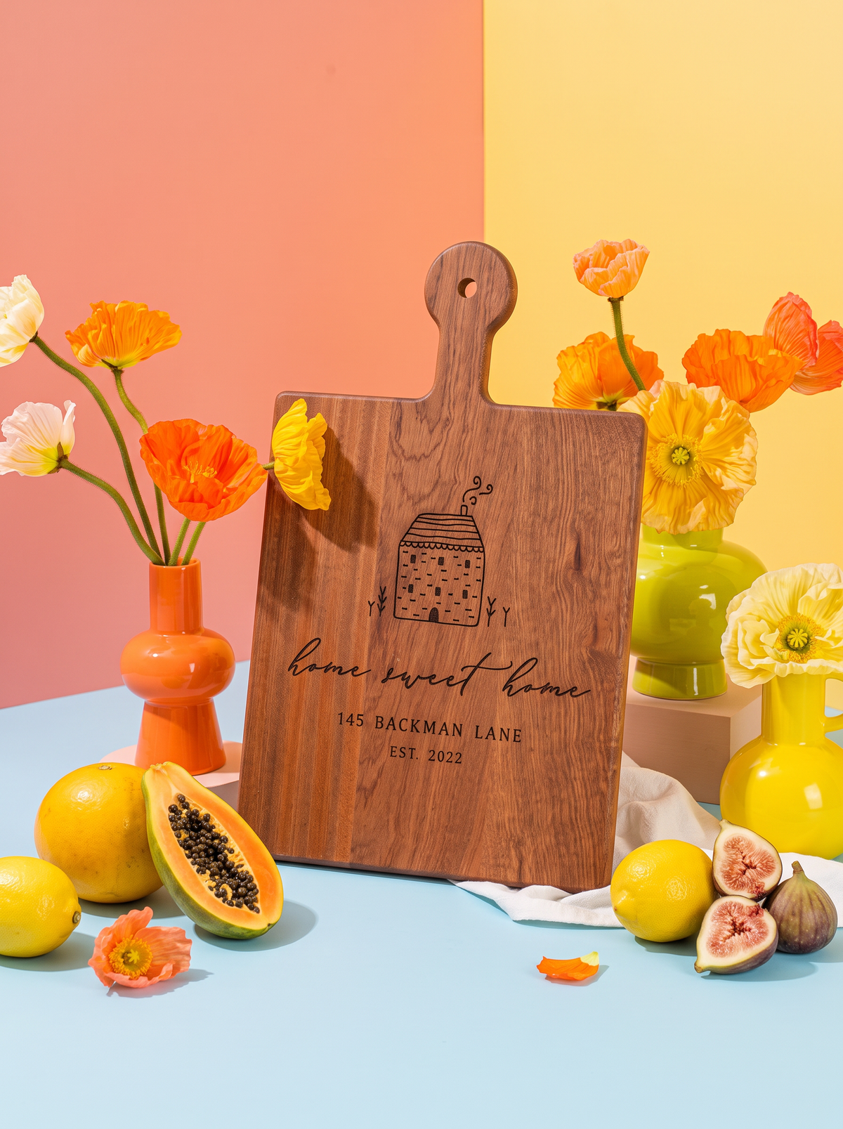 Home Sweet Home Cottage Cutting Board in a colorful floral setting