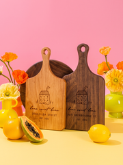 Home Sweet Home Cottage Cutting Board in a colorful floral setting
