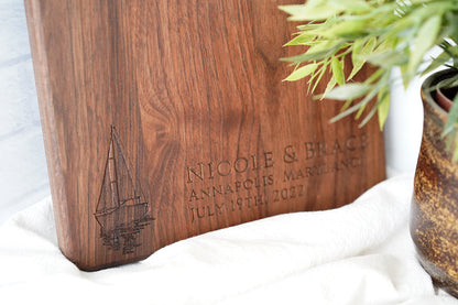 a wooden cutting board sitting next to a potted plant