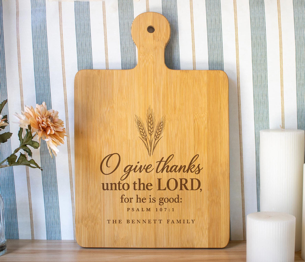 Edited PSD composite mockup of a broad bamboo paddle board with the O give thanks wheat design and The Bennett Family personalization.
