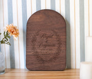 Edited mockup of first loved wreath on an arched board, personalized with Abigail and Benjamin and June 12, 2027.