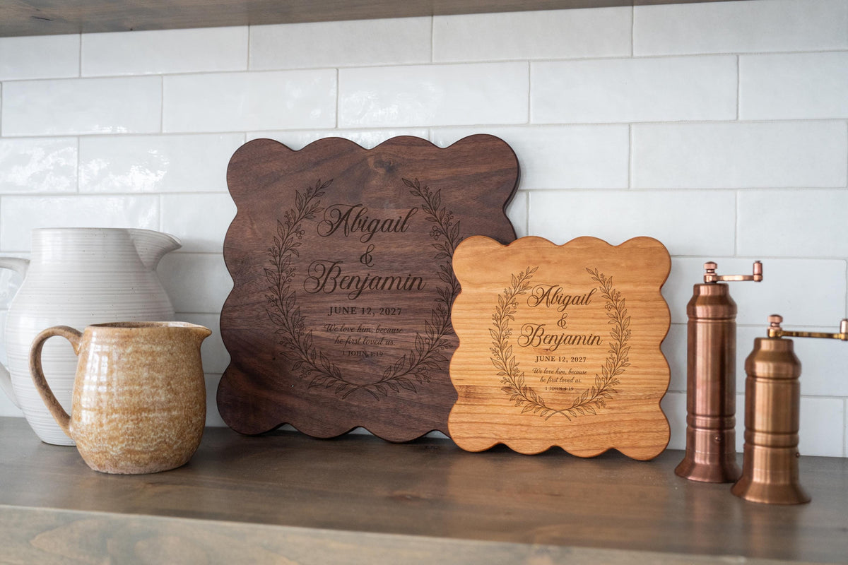 Edited mockup showing two scalloped square board examples with first loved wreath, names, date and scripture; board options shown separately.