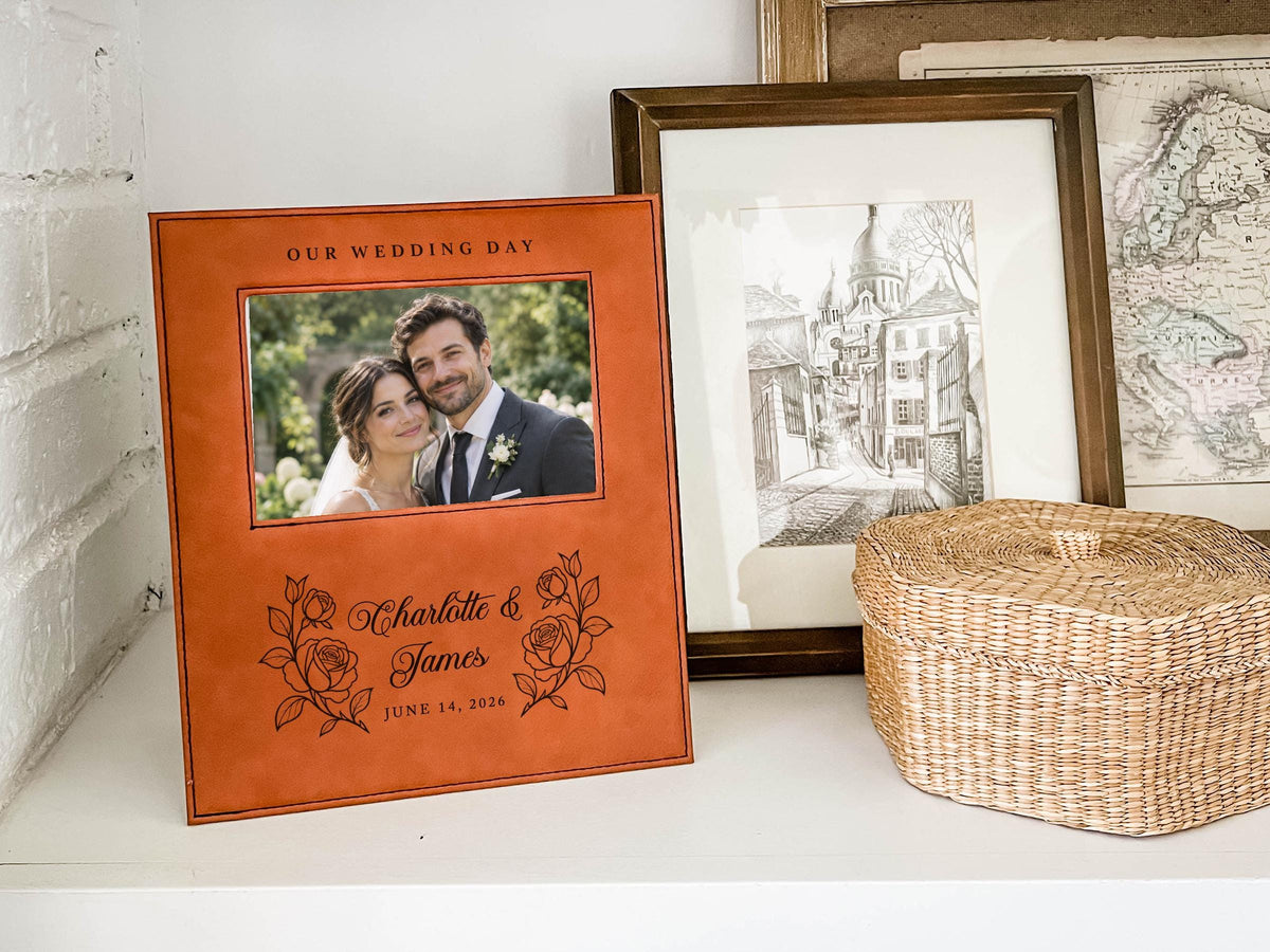 Wedding Roses frame mockup with a sample wedding photo, OUR WEDDING DAY, roses, Charlotte & James and June 14, 2026, on a shelf beside a woven basket.