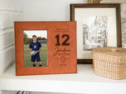 Edited Varsity Soccer frame mockup with an illustrative soccer player portrait on the left and sample Westfield High School, number 12, Jordan Miller and 2026 engraving on the right.