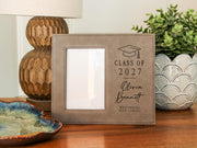 Grad Cap engraved frame reading Class of 2027, Olivia Bennett, Westbridge High School, with its original empty photo opening. Edited mockup with sample personalization.