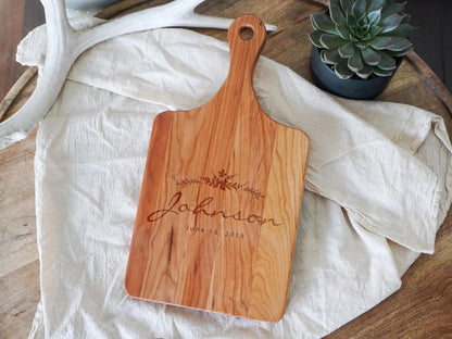 a wooden cutting board sitting on top of a table