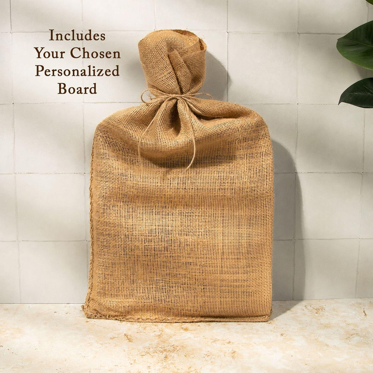A burlap sack tied with a string, placed on a white tiled surface against a white wall.