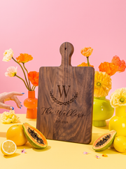 Large Initial Family Name Cutting Board in a colorful floral setting