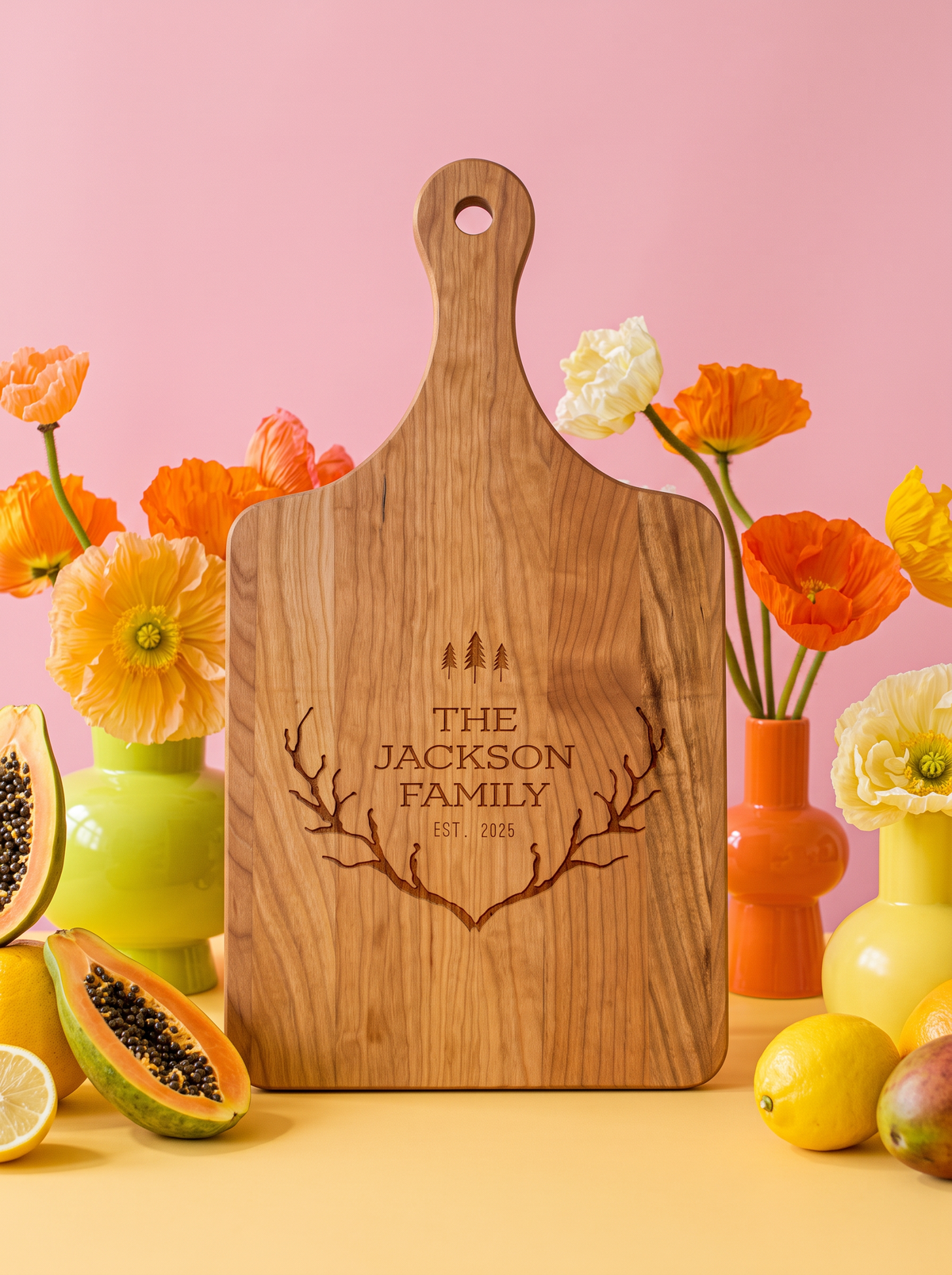Wood paddle cutting board with antlers, pine trees, family name and established year engraving, view 1.