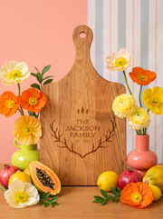 Wood paddle cutting board with antlers, pine trees, family name and established year engraving, view 2.