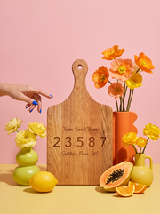 Home Sweet Home Zip Code Cutting Board in a colorful floral setting