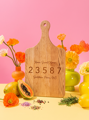Home Sweet Home Zip Code Cutting Board in a colorful floral setting